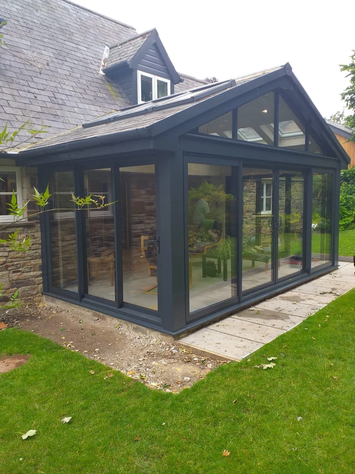 A house with a large glass door and a patio.