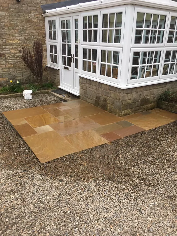 A house with a stone walkway in front of it.