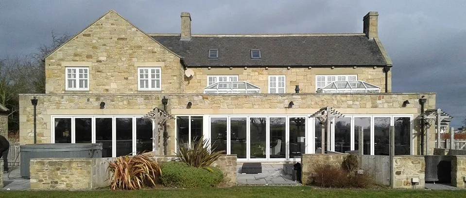 A large stone building with windows and doors.