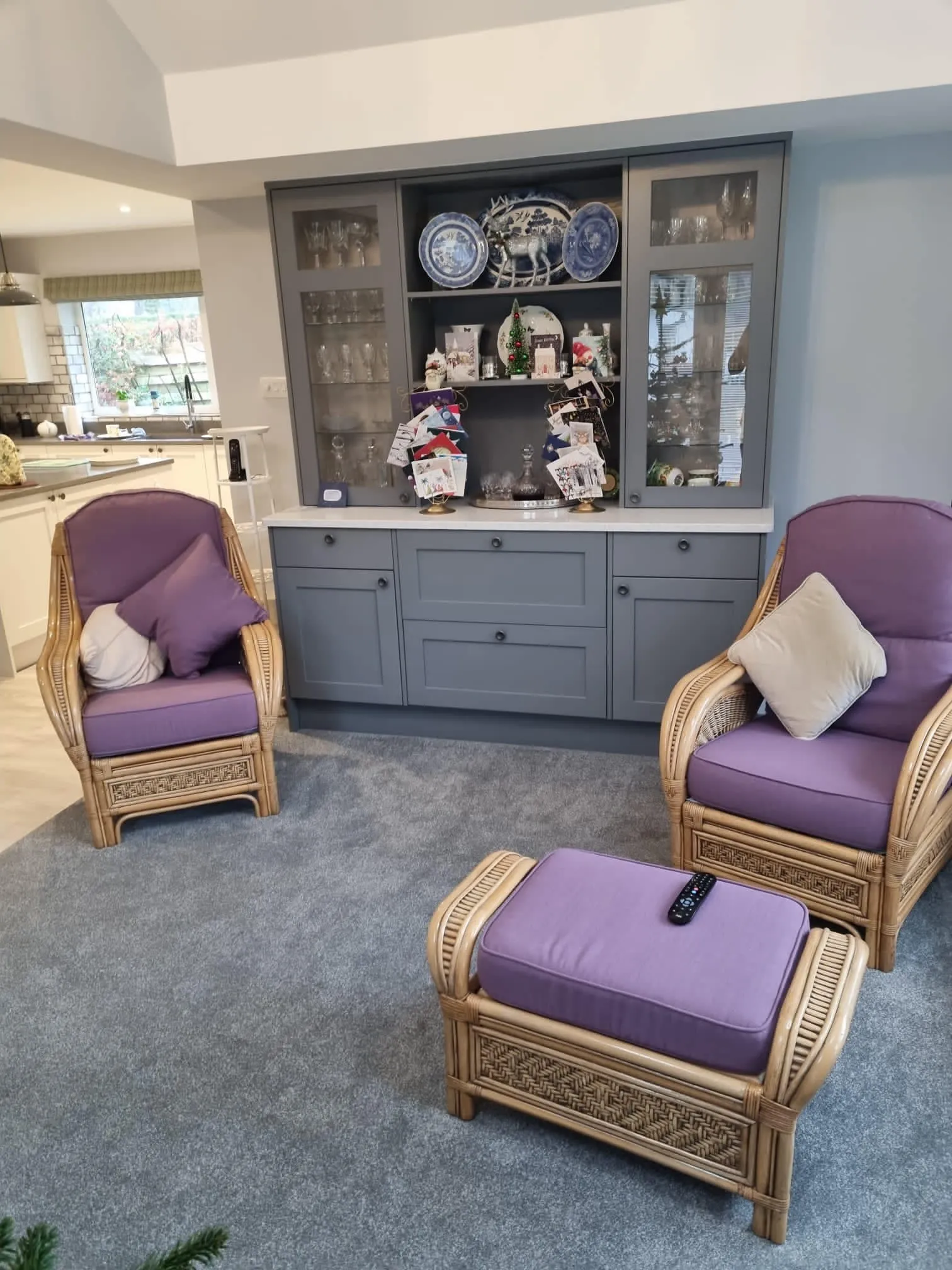 A living room with two chairs and a ottoman.